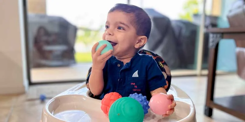 Baby Cyrus playing with colored balls