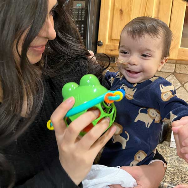 Photograph of Baby Cyrus playing with a toy